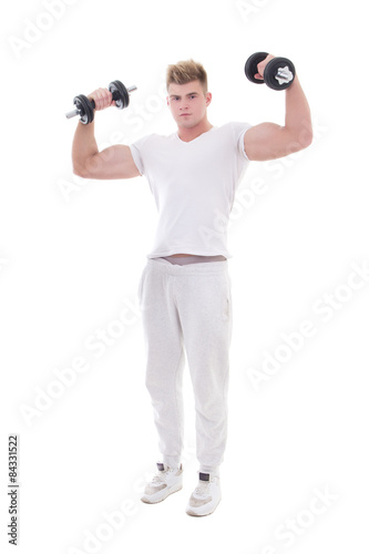 young handsome man in sportswear doing exercises with dumbbells