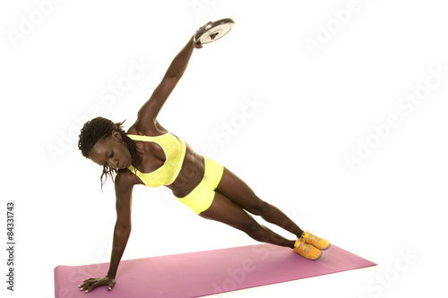 African American woman fitness green outfit side plank weight up