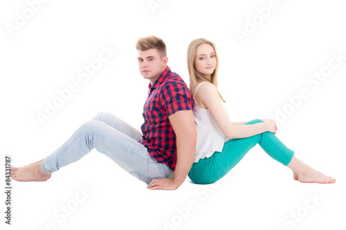 teenage love concept - young couple sitting on the floor isolate
