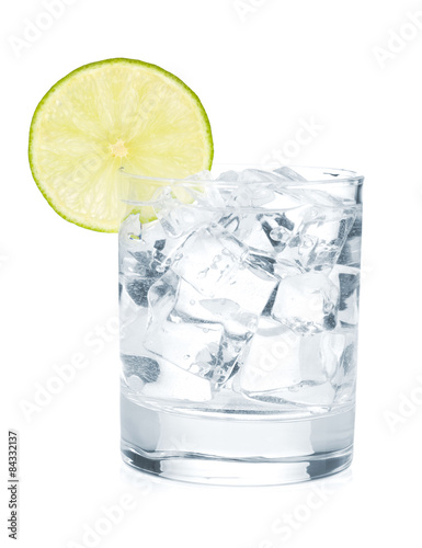 Glass of pure water with ice cubes and lime slice