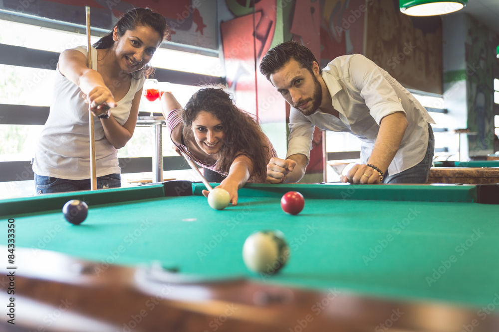 group of friends playing pool - obrazy, fototapety, plakaty 
