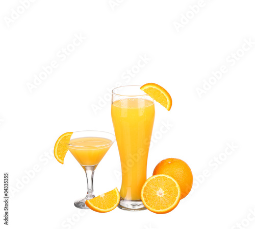 Glass of freshly pressed orange juice with sliced orange 