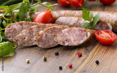 Smoked sausages with herbs, greens,  tomatoes