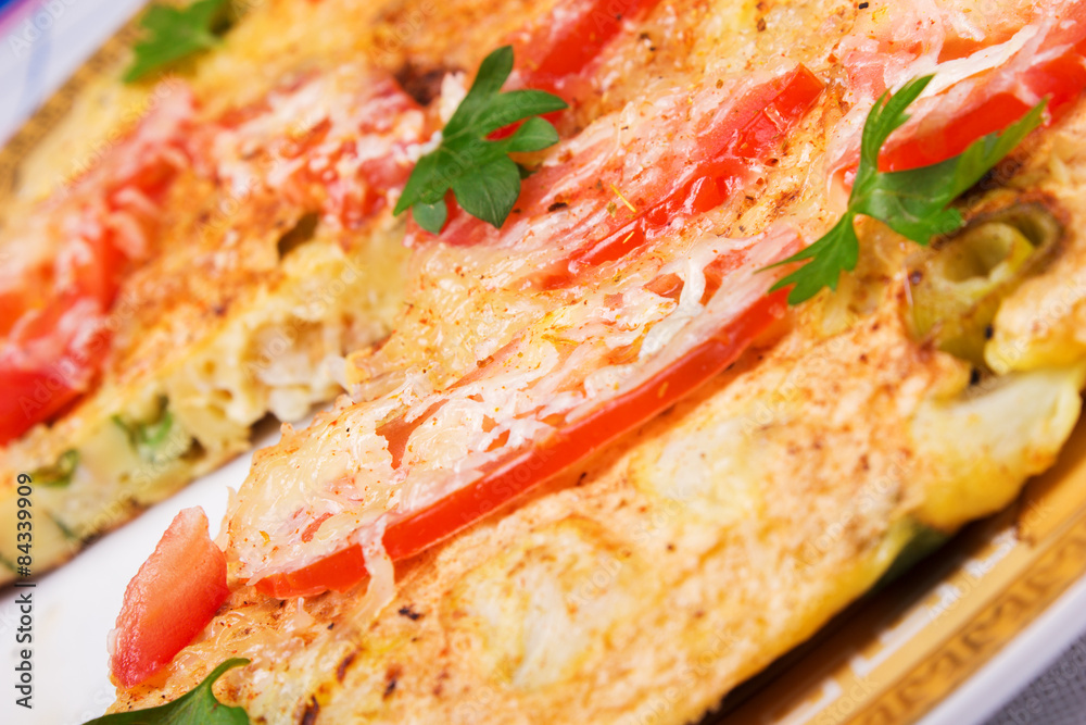 Omelet with cauliflower, tomatoes, fresh herbs and cheese 