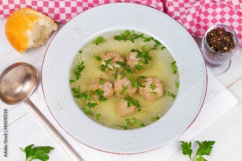 Meatballs in broth with parsley