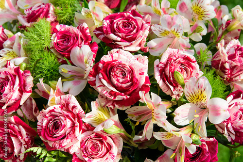 Mixed boquet of red-and-white roses and lilies