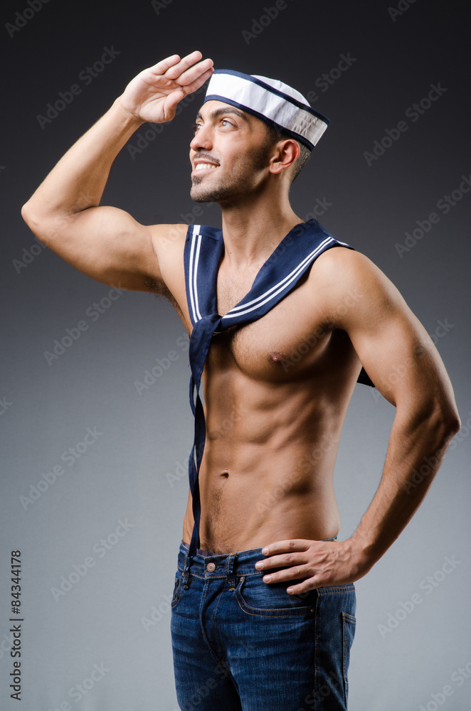 Ripped sailor against dark background