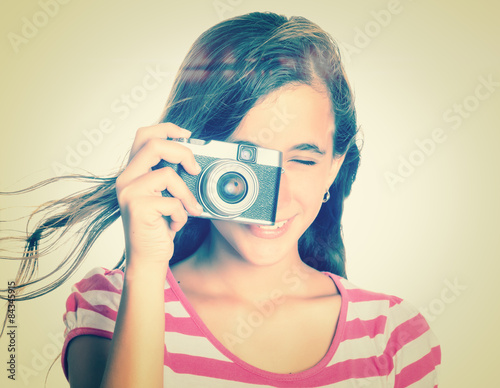Teenage girl using a vintage camera