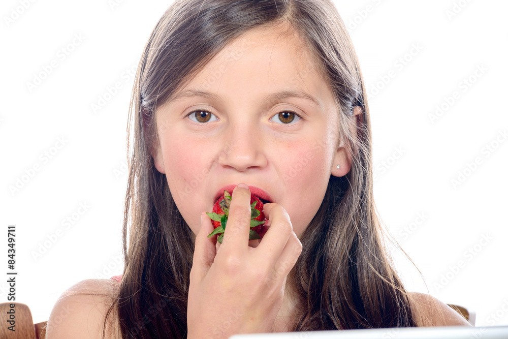 a little girl eating a strawberry a little girl eating a strawberry