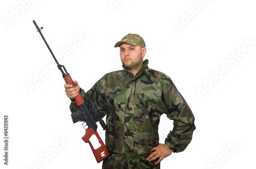 Young man in soldier uniform holding gun isolated on white
