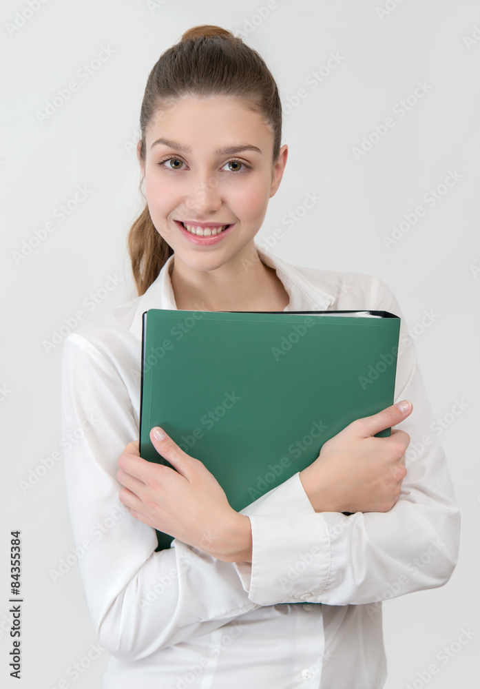 student in white shirt with green folder looking to the camera student in white shirt with green folder looking to the camera
