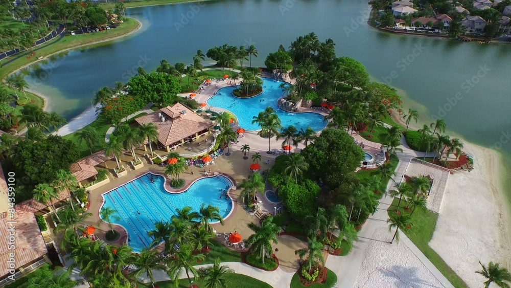Aerial video of people swimming in a community pool