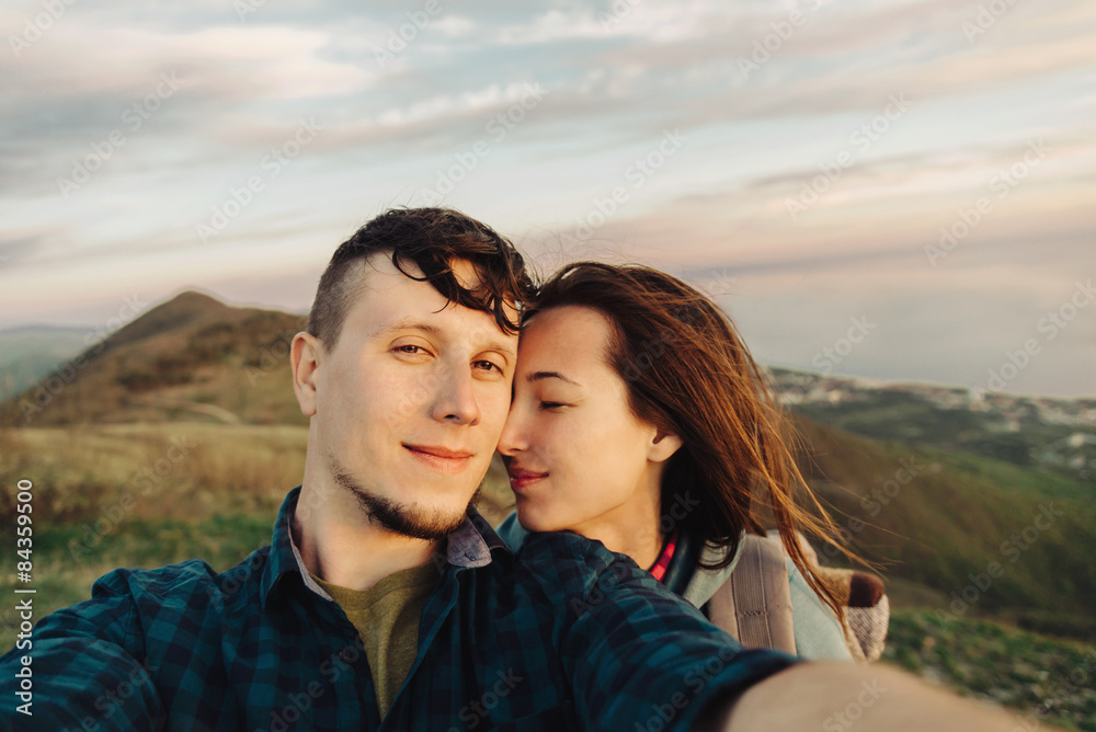 Happy loving couple taking self-portrait outdoor Happy loving couple taking self-portrait outdoor