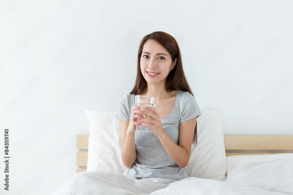 Young woman drinking water at morning Young woman drinking water at morning