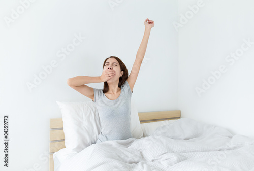 Woman waking up in her bedroom