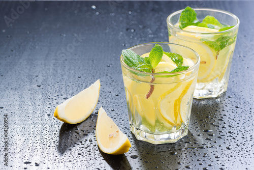 Fresh lemonade with mint in glasses on a dark background