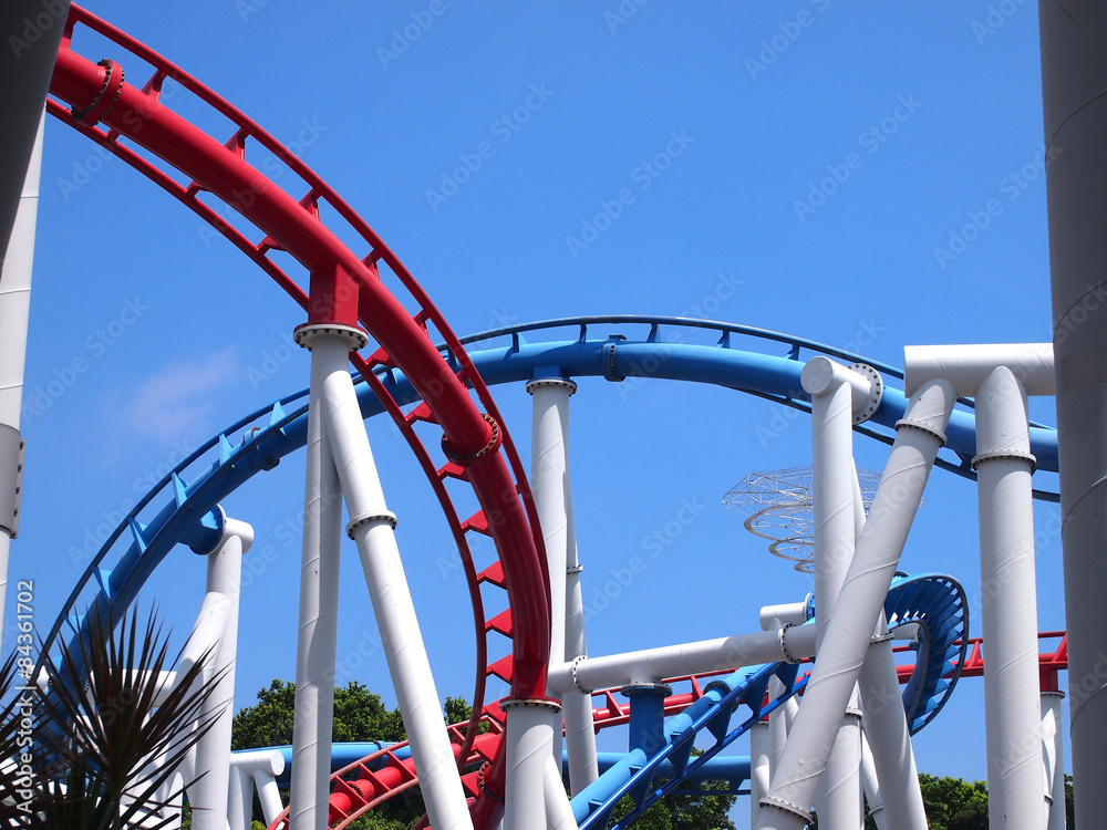 a roller coaster's loop with blue sky a roller coaster's loop with blue sky