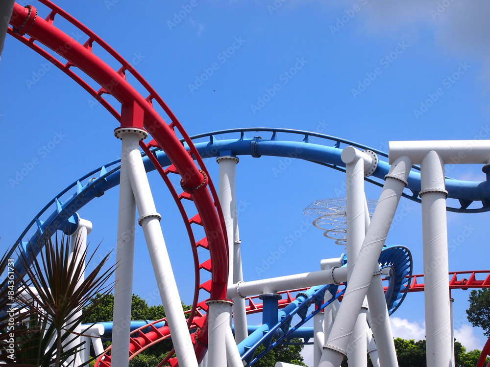 a roller coaster's loop with blue sky a roller coaster's loop with blue sky