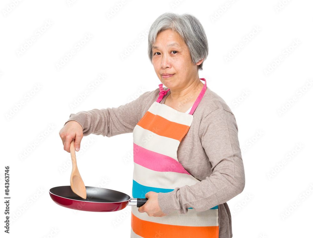 Asian old housewife making food