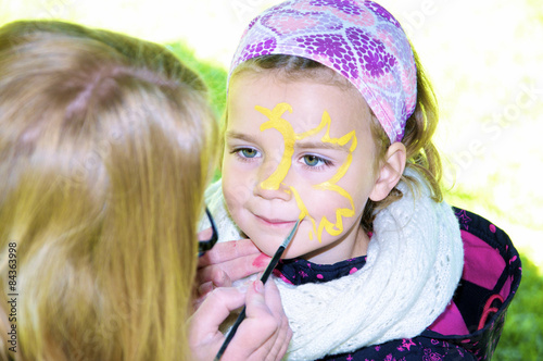 Kinderschminken - Kleines Mädchen erhält Gesichtsbemalung