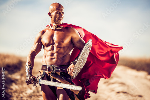 Gladiator, image of a well-built man holding a sword and a shiel