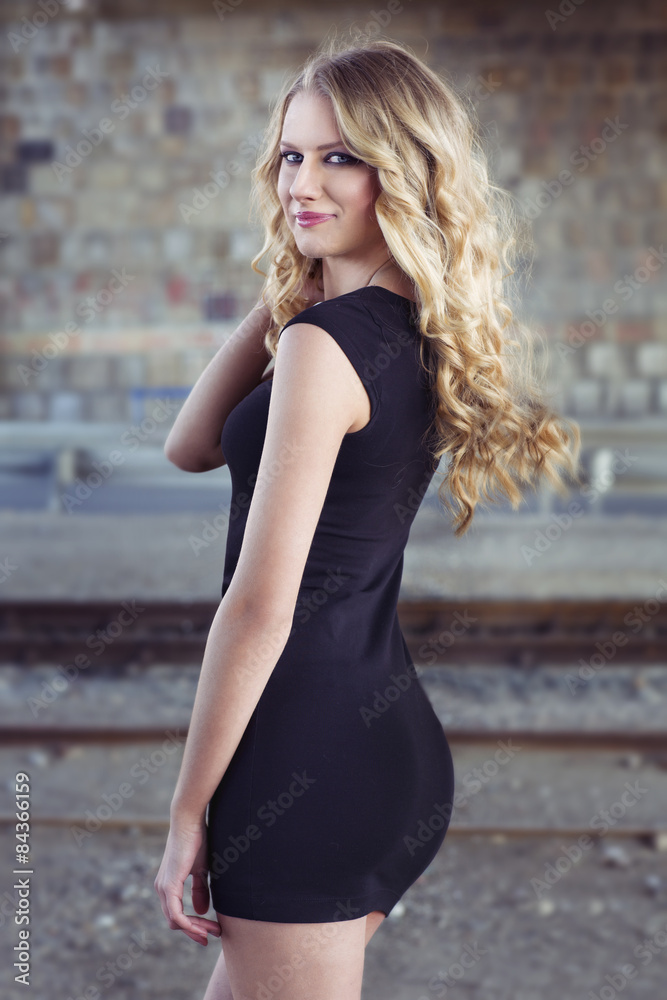 Beautiful blond woman in black dress