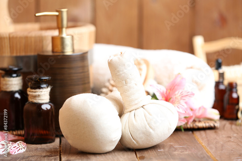 Beautiful spa composition with massage bags on table close up