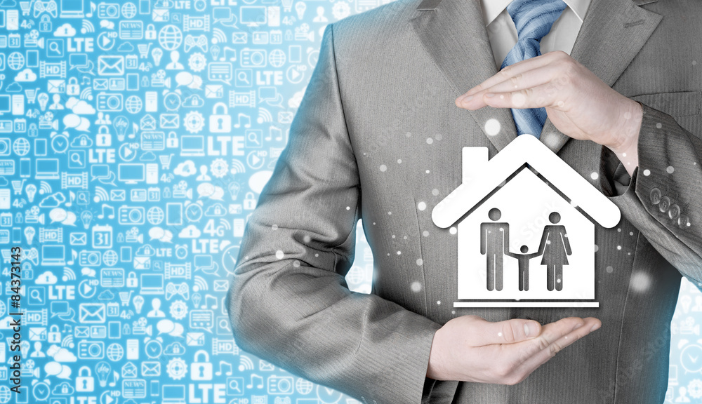businessman protecting family in home with hands businessman protecting family in home with hands
