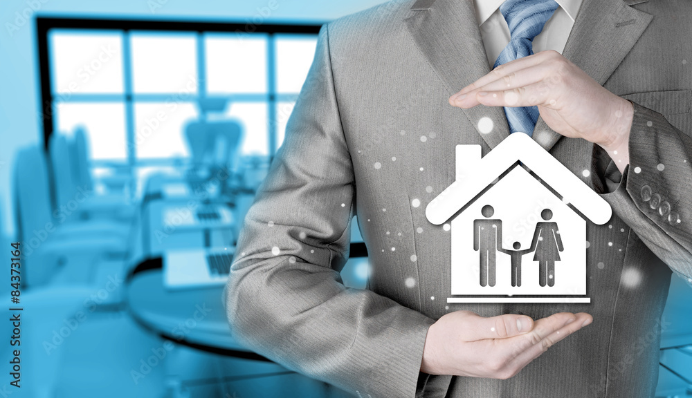 businessman protecting family in home with hands businessman protecting family in home with hands