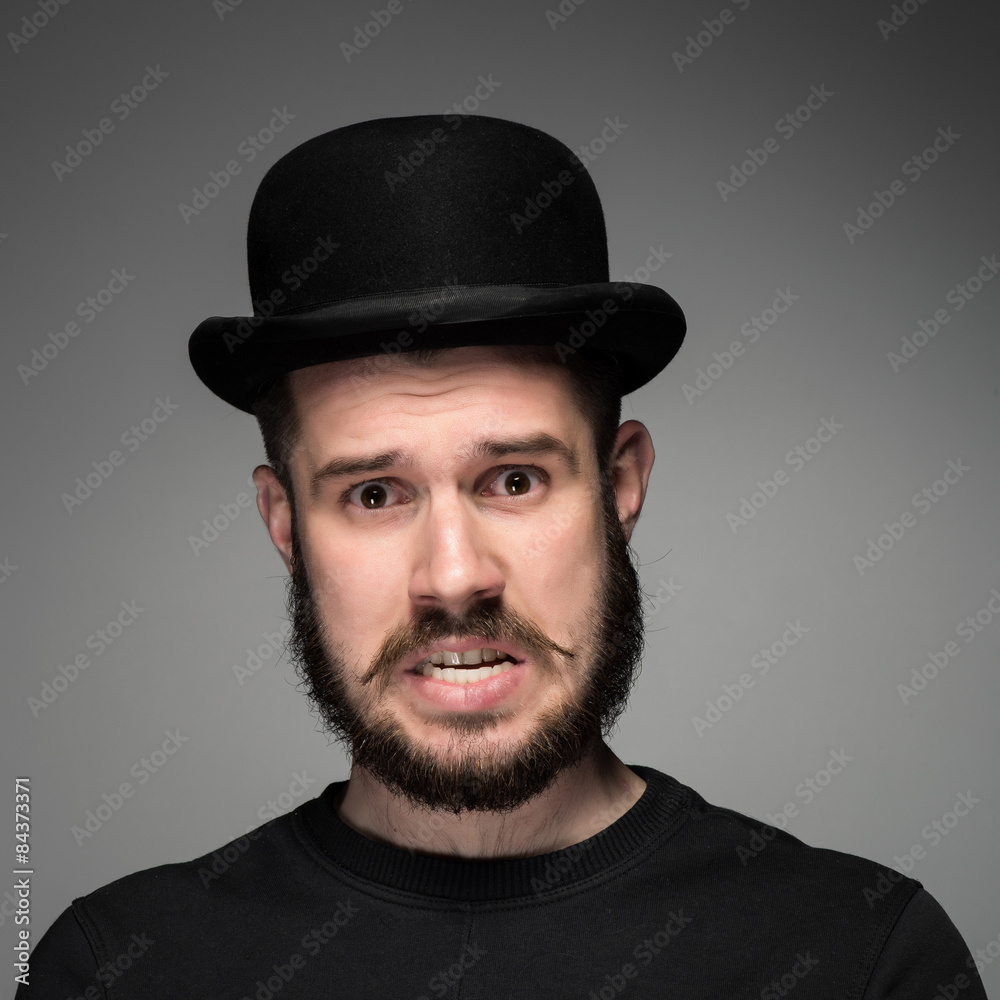 Portrait of young indignant man in studio Portrait of young indignant man in studio