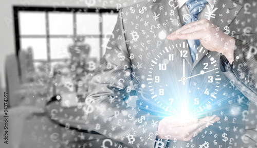 Image of businessman holding clock against illustration