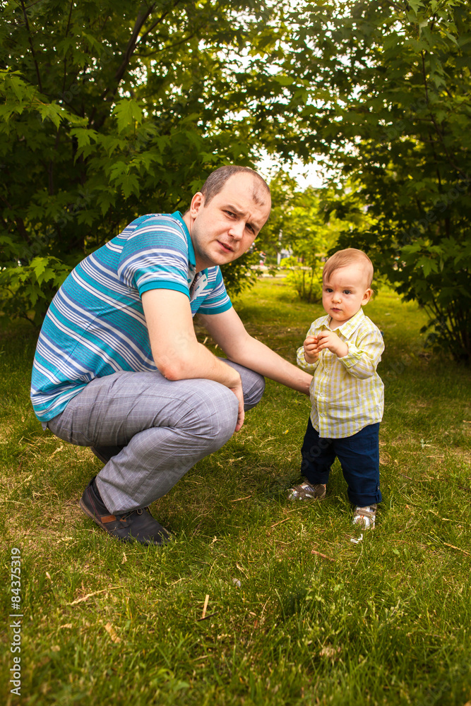 Fototapeta premium father and son walking in the park