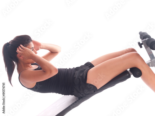 girl doing sit-ups on a bench
