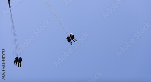 some persons in a ride high up in the air on an amusement field