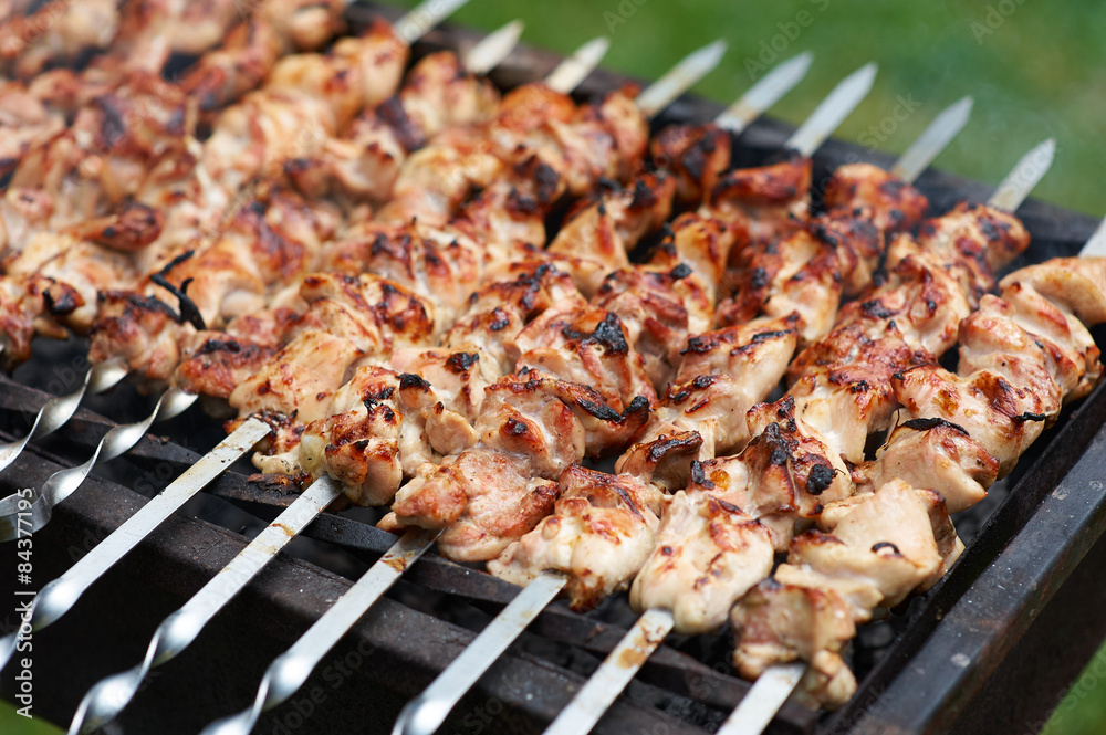 Grilling shashlik on barbecue grill with delicious meat
