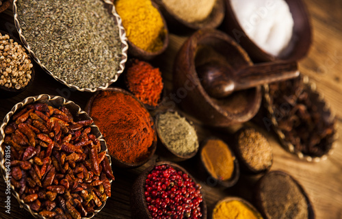 Wooden table of colorful spices © dianaduda