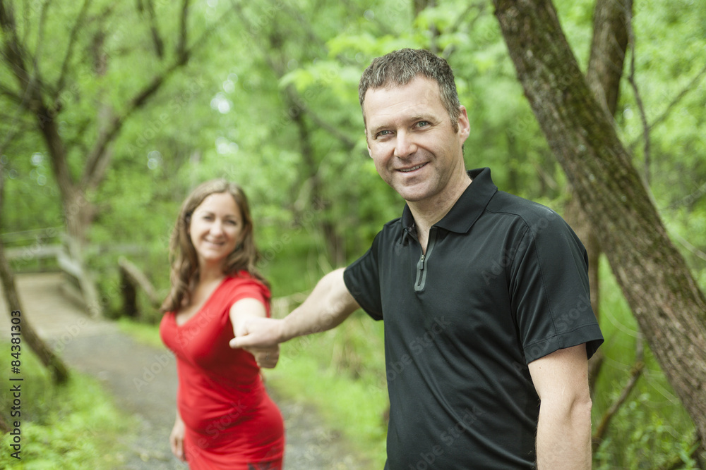 A couple standing on forest trail