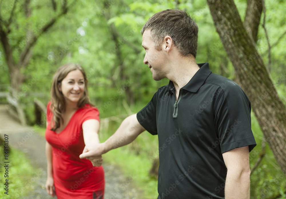 A couple standing on forest trail