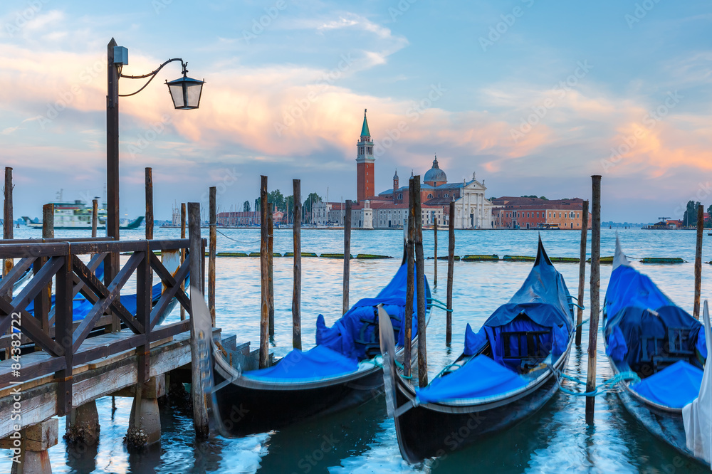 Gondolas at twilight in Venice lagoon, Italia