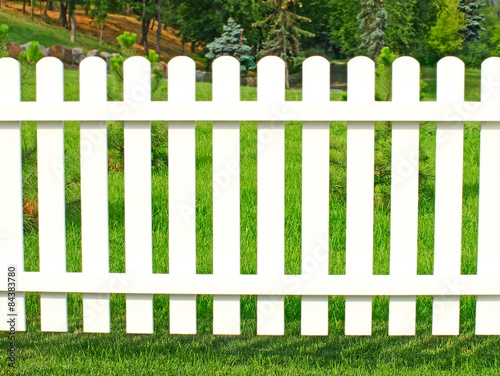 White fence in garden.