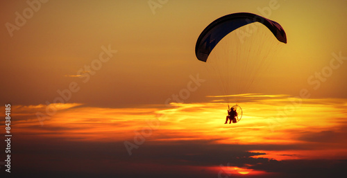 man enjoying paraglide on sky