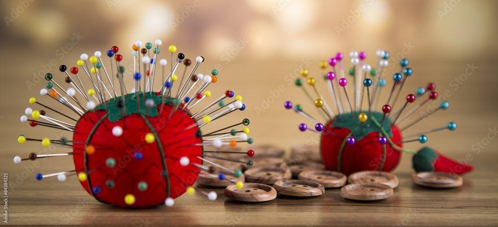 A set of colored sewing thread. Garment buttons, pins.