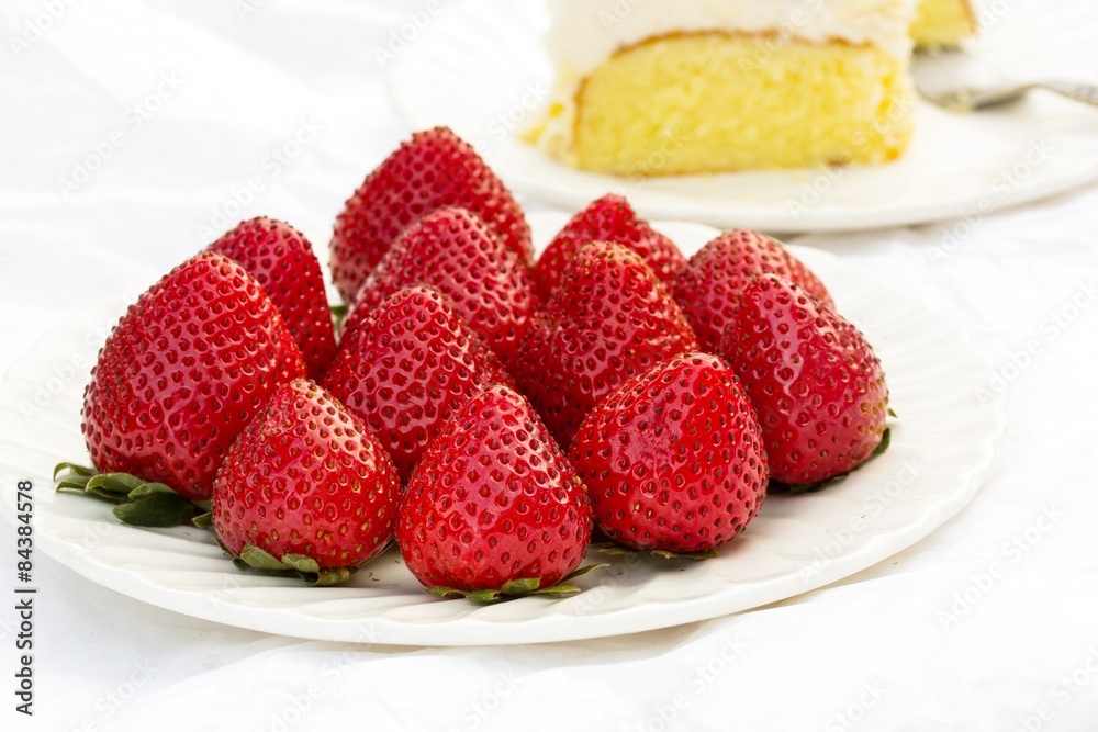 Fresh Strawberries on plate with cake on side, selective focus Fresh Strawberries on plate with cake on side, selective focus