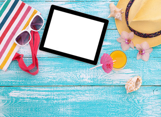 Blank empty tablet computer, summer accessories on beach. 