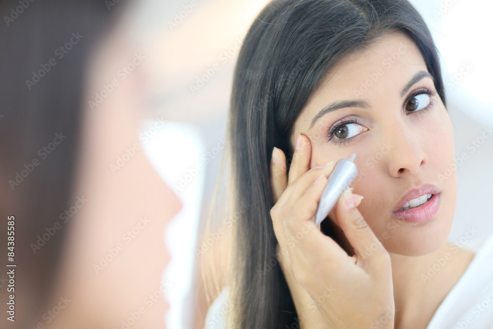 Portrait of beautiful woman using cosmetics Portrait of beautiful woman using cosmetics