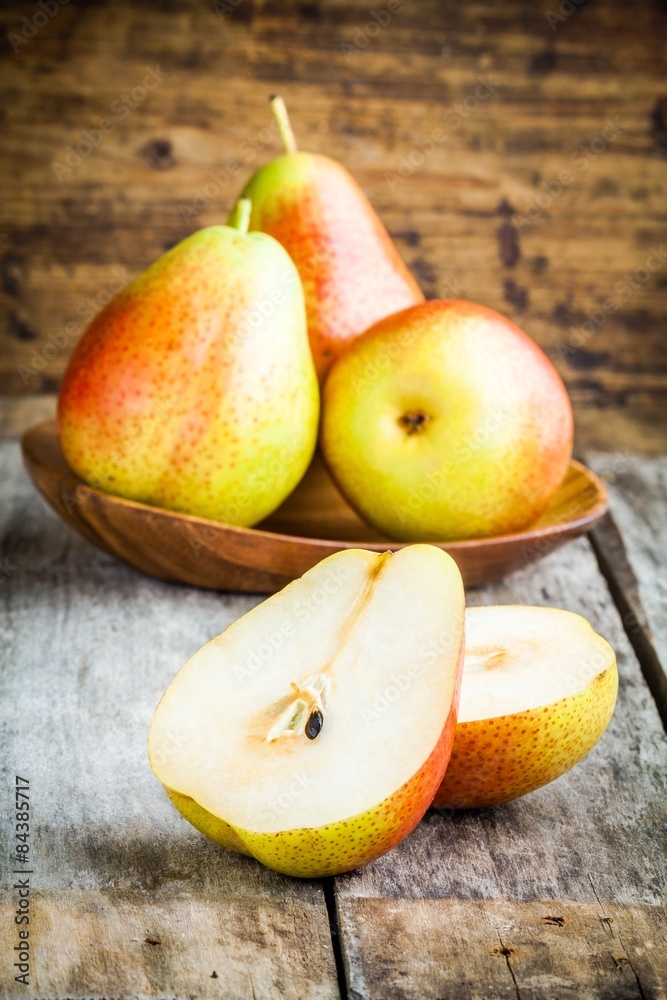Three fresh ripe organic pears and sliced one Three fresh ripe organic pears and sliced one