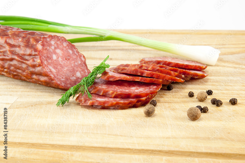 salami sausages on wooden board isolated salami sausages on wooden board isolated