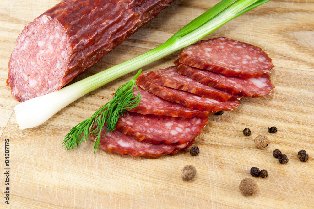 salami sausages on wooden board isolated