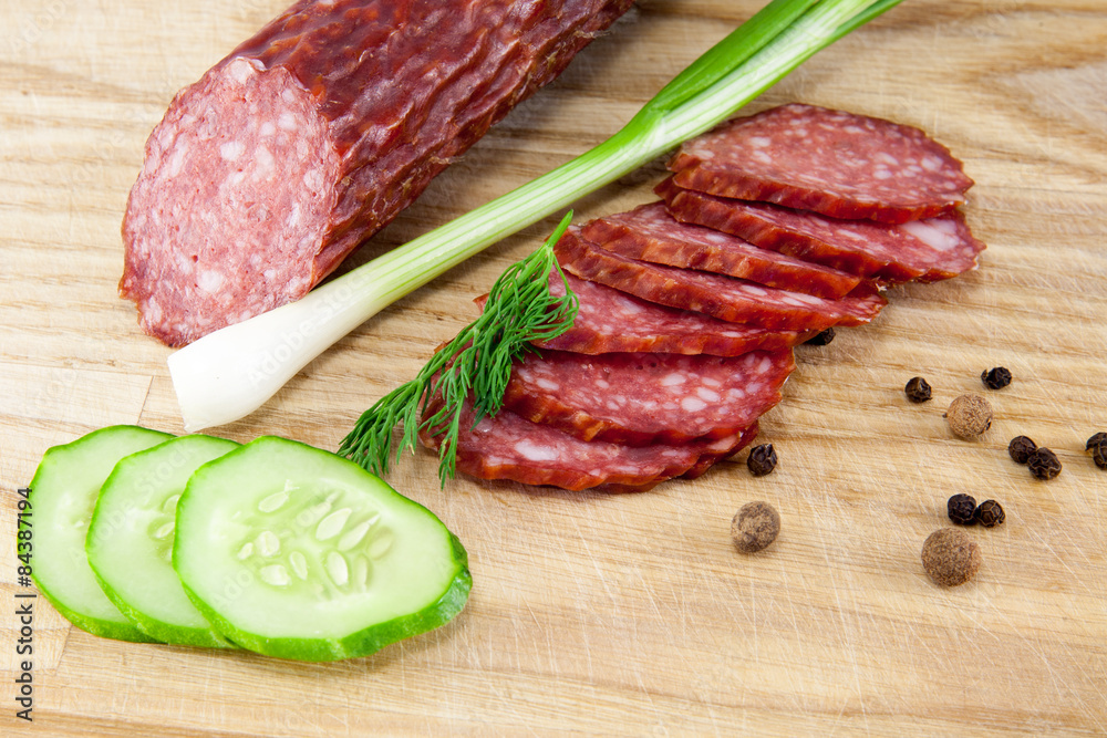 salami sausages on wooden board isolated salami sausages on wooden board isolated