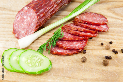 salami sausages on wooden board isolated